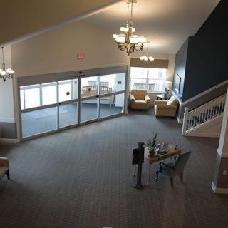 A spacious lobby with comfortable seating and elegant chandeliers.