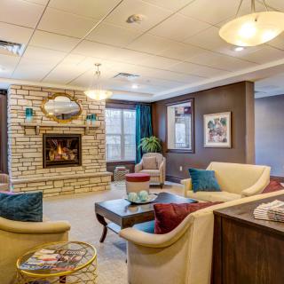 A cozy living room with a central fireplace and comfortable seating arrangement.