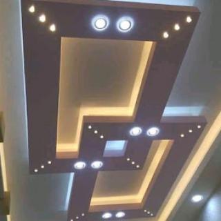 A stylish modern ceiling design featuring integrated lighting.