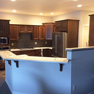 Modern kitchen with wooden cabinets and a large countertop.