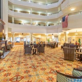 A spacious hotel lobby with seating areas and an atrium.