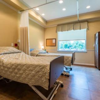 A clean and modern hospital room with two patient beds.