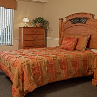 A cozy bedroom with wooden furniture and a warm color scheme.