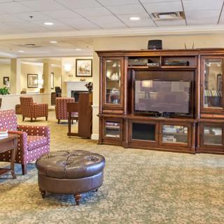 A cozy living room with a large entertainment center and comfortable seating.