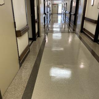 A long hallway with multiple doors on either side.
