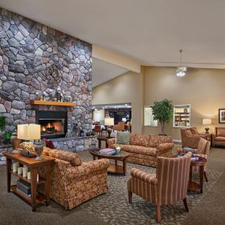 A cozy lobby with a stone fireplace and comfortable seating arrangements.