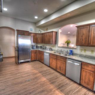 A modern kitchen featuring wooden cabinets and stainless steel appliances.