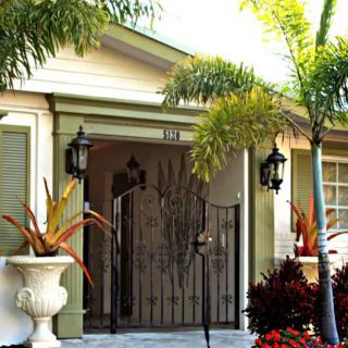 House entrance with decorative plants and lanterns.