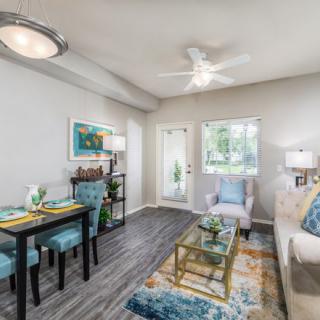 A modern and cozy living room featuring a dining area, stylish furnishings, and tasteful decor.