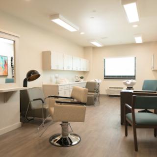A modern and well-lit medical office featuring comfortable seating and professional decor.