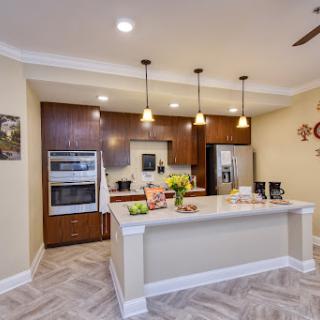 A modern kitchen featuring sleek cabinets, stainless steel appliances, and elegant lighting.