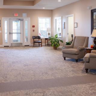 A cozy living room with comfortable seating and decorative elements.