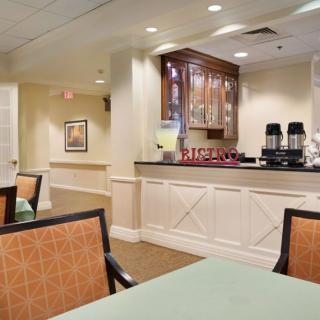 A cozy dining area with a coffee station and comfortable seating.