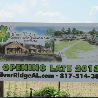 A billboard advertising the upcoming opening of Silver Ridge Assisted Living and Memory Care, scheduled for late 2013.
