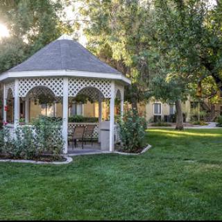 A serene gazebo nestled in a lush garden, perfect for relaxation.