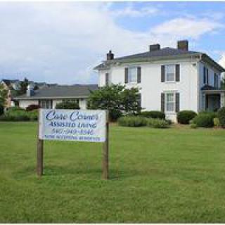 A large house with a sign advertising for an open house event on the lawn.