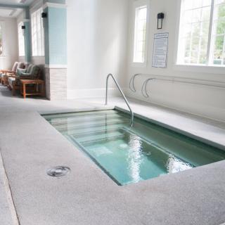 An inviting indoor hot tub in a serene spa setting.