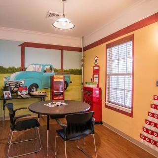 A retro-themed diner interior with vintage decor and a wall mural.