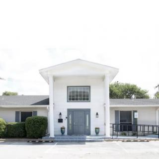 A white building with large columns and a central entrance.