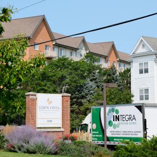 A residential building with a truck in front and a sign for 'Integra'.