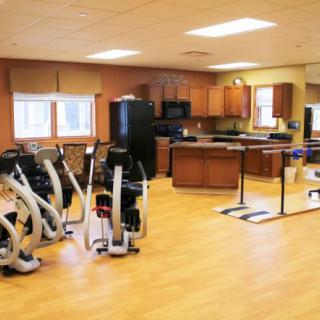 A rehabilitation room equipped with exercise machines and therapy areas.