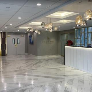 A modern lobby with marble flooring and elegant lighting fixtures.
