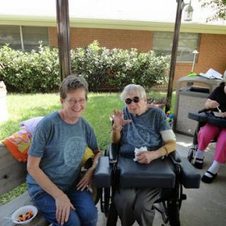Two friends enjoying a sunny day outdoors, sharing smiles and moments together.