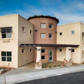 A modern commercial building with a stucco exterior and distinctive architectural design.
