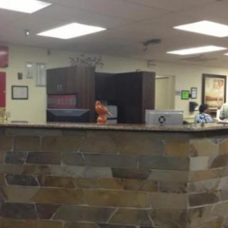 Reception area with stone-front desk and office interior.