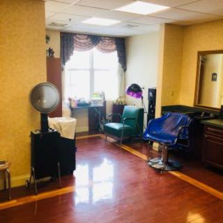 A cozy hair salon interior with styling chairs and equipment.