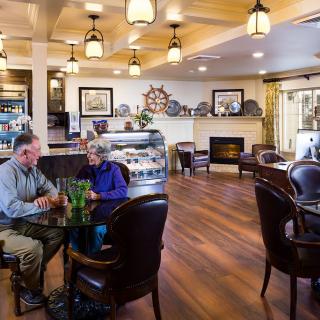 A cozy cafe with comfortable seating and warm lighting, where people enjoy a relaxing conversation.