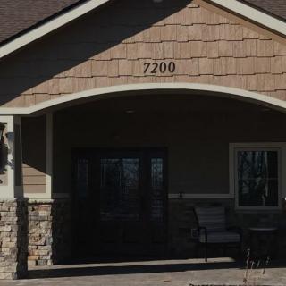 An entrance to a building with the house number 7200 displayed above the door.