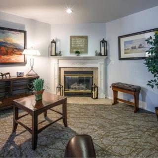 A cozy living room with a fireplace and stylish furniture.