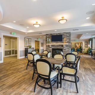 A cozy dining area with modern design, featuring a fireplace and stylish seating arrangements.