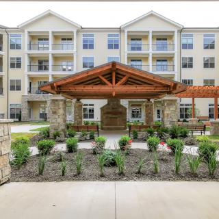 A modern apartment building with a landscaped entrance.