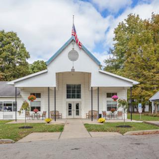 A charming community center featuring a welcoming front entrance and vibrant landscaping.