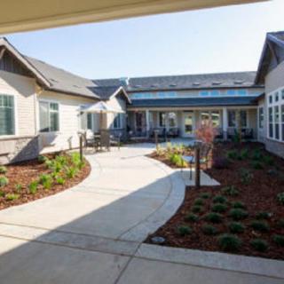 A modern courtyard with landscaped gardens and multiple buildings.