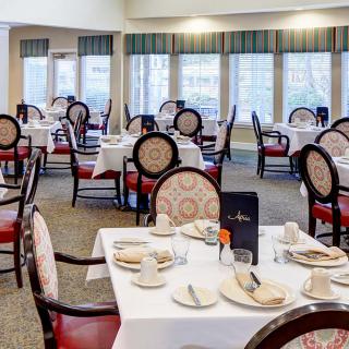 A well-arranged restaurant dining area with elegantly set tables and chairs.
