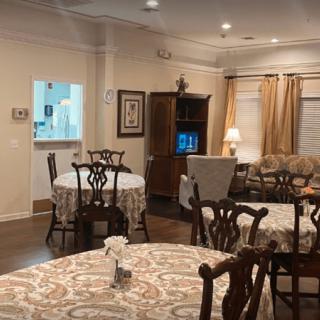 Cozy living and dining area with classic furniture and warm lighting.