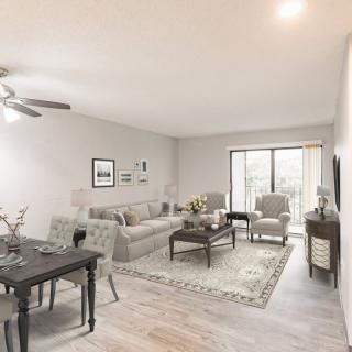 A modern and cozy living room with a comfortable sofa, stylish dining area, and elegant decor.