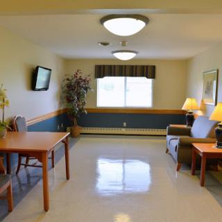 A cozy living area featuring a dining table, comfortable seating, and natural light from the window.