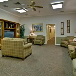 A cozy living room with comfortable seating and a television entertainment center.