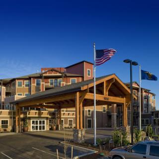 A hotel building with a grand entrance and flags flying outside.