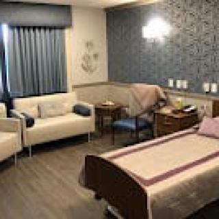 A modern hospital room with comfortable seating and a well-designed layout.