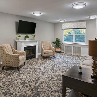A cozy living room with a fireplace, television, and comfortable seating arrangement.