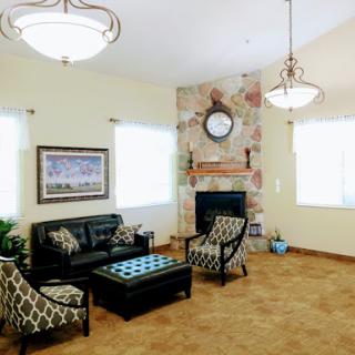 A cozy living room featuring modern furniture and a stylish fireplace.