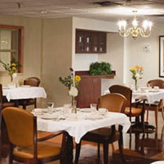 A cozy restaurant dining area with neatly set tables and ambient lighting.