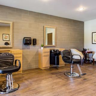 A modern salon interior with barber chairs and mirrors.