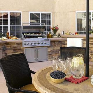 A cozy outdoor patio with a barbecue grill and seating area.