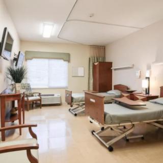 A well-lit hospital room with two beds, designed for patient care.